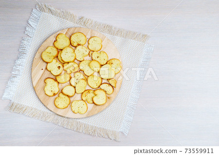 homemade croutons from white bread on a wooden board top view. copyspace 73559911