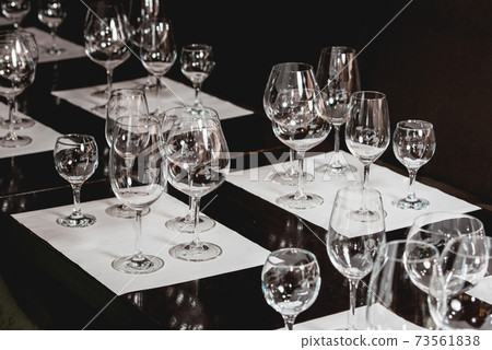empty glasses of different shapes served for a wine tasting 73561838