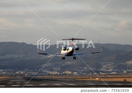 Landing of IBEX Bombardier CRJ700NG at dusk (Senri River bank at Itami Airport) 73561939