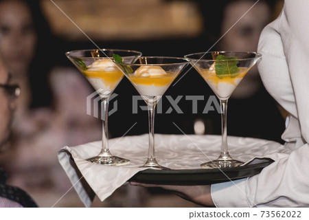 Waiter serving ice cream desert 73562022