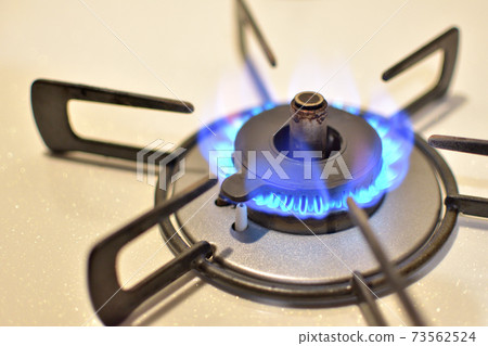 A gas stove that is on fire 73562524