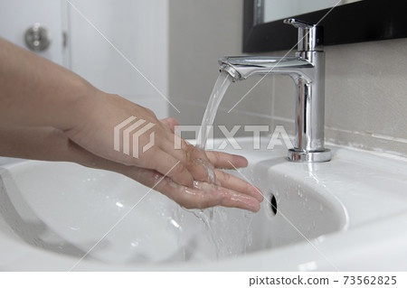 Men are washing their hands in the sinks to clear respiratory bacteria and viruses, sanitation and reduce the spread of COVID-19 that is spread around the world, Hygiene ,Sanitation concept. Men are washing their hands in the sinks to clear respiratory bacteria and viruses, sanitation and reduce the spread of COVID-19 that is spread around the world, Hygiene ,Sanitation concept. 73562825