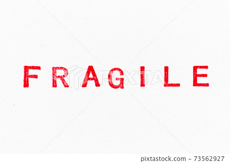 Red color fragile word ink rubber stamp on white paper background Red color fragile word ink rubber stamp on white paper background 73562927
