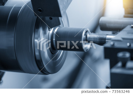 The  CNC lathe machine bore cutting the metal shaft. 73563246