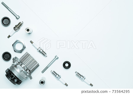 Auto valve. Motor mechanic spare or automotive piece isolated on white background. Set of new metal car part. Flat lay, top view, copy space. Auto valve. Motor mechanic spare or automotive piece isolated on white background. Set of new metal car part. Flat lay, top view, copy space. 73564295