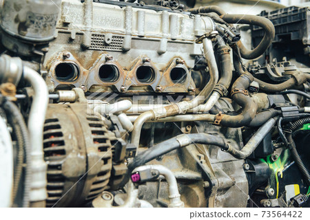 Close-up, internal combustion engine repair. Close-up, internal combustion engine repair. 73564422