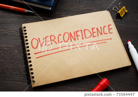 Overconfidence concept word written on the page. Overconfidence concept word written on the page. 73564447