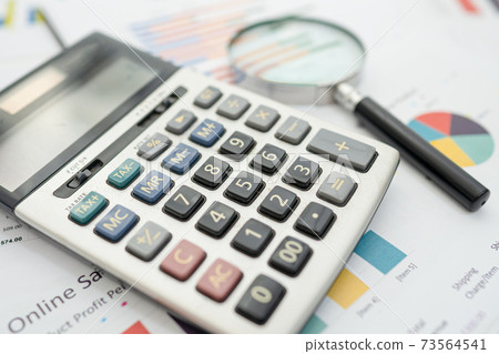 Calculator on chart and graph paper. Finance development, Banking Account, Statistics, Investment Analytic research data economy, Stock exchange trading, Business company concept. 73564541