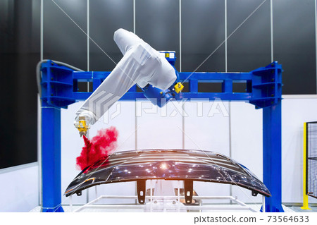 Robotic arm painting spray to the automotive part. High-technology manufacturing concept. Robotic arm painting spray to the automotive part. High-technology manufacturing concept. 73564633