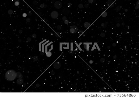 Bokeh of white snow on a black background. Snowfall - design element. Bokeh of white snow on a black background. Snowfall - design element. 73564860