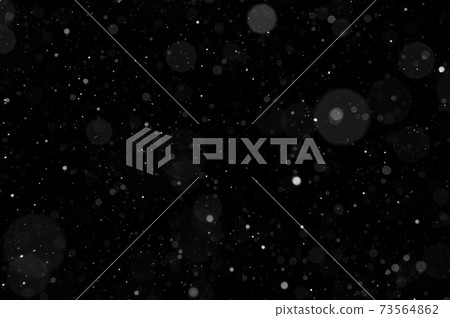 Bokeh of white snow on a black background. Snowfall - design element. 73564862