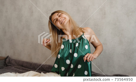 Beautiful smiling blonde in green pajamas. Good morning concept Beautiful smiling blonde in green pajamas. Good morning concept 73564950