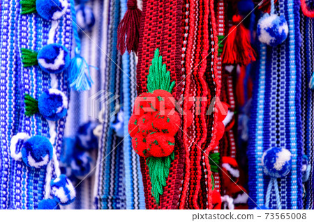 Colorful Ukrainian belts are decorated with embroidery on a shop window Colorful Ukrainian belts are decorated with embroidery on a shop window 73565008