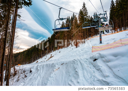 Ski lifts of holiday complexes. In the Carpathians, winter landscape. Ski lifts of holiday complexes. In the Carpathians, winter landscape. 73565383