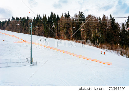 Ski lifts of holiday complexes. In the Carpathians, winter landscape. Ski lifts of holiday complexes. In the Carpathians, winter landscape. 73565391