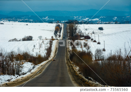An irritated driver moves slowly on extremely poor Ukrainian roads 73565560