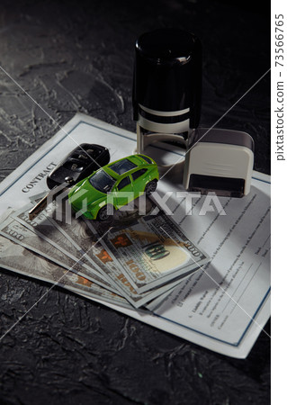 Purchase contract for a car with stamps, keys and toy car. Vertical image Purchase contract for a car with stamps, keys and toy car. Vertical image 73566765