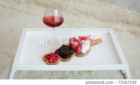 Breakfast for girlfriend. Valentines Day Morning. Wine and sweets on white tray Breakfast for girlfriend. Valentines Day Morning. Wine and sweets on white tray 73567288
