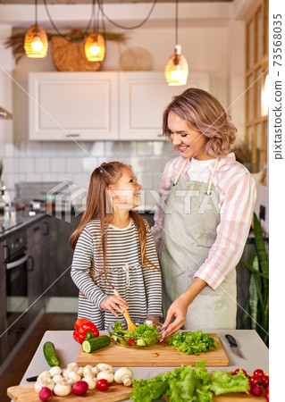 portrait of caucasian family mother with daughter cooking together 73568035