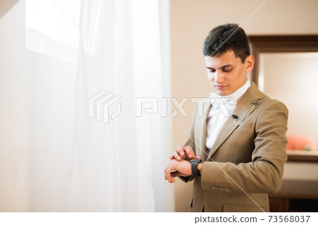 Young handsome man relaxing at his apartment in a hotel after business meeting Young handsome man relaxing at his apartment in a hotel after business meeting 73568037