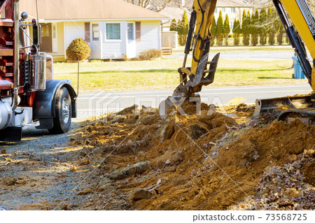 Excavator machine unloading soil earth moving 73568725
