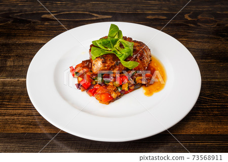 Juicy piece of meat with stewed vegetables 73568911