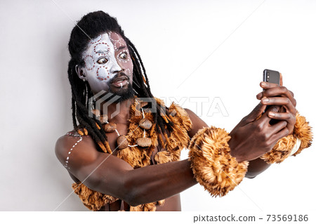shocked african primitive male using mobile phone shocked african primitive male using mobile phone 73569186