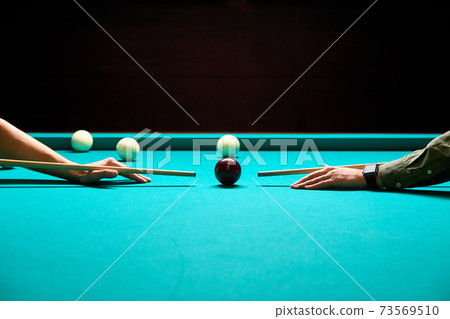 snooker - close-up shot of a two men playing billiard snooker - close-up shot of a two men playing billiard 73569510