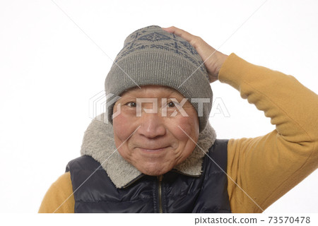 A smiling Japanese senior man wearing a knit hat A smiling Japanese senior man wearing a knit hat 73570478