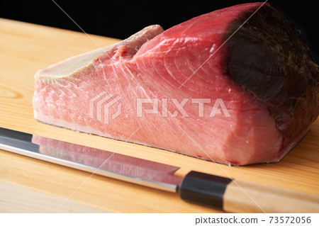 Tuna block on a cutting board 73572056