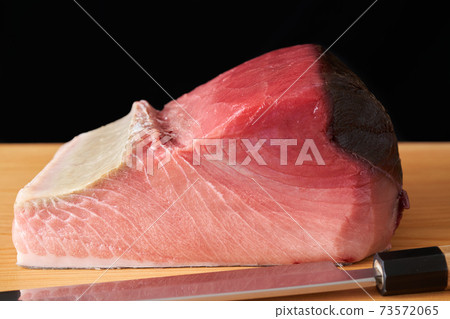 Tuna block on a cutting board 73572065
