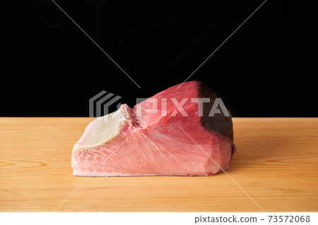 Tuna block on a cutting board 73572068