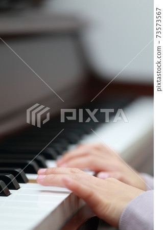 5-year-old girl playing an upright piano 5-year-old girl playing an upright piano 73573567