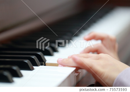 5-year-old girl playing an upright piano 73573593