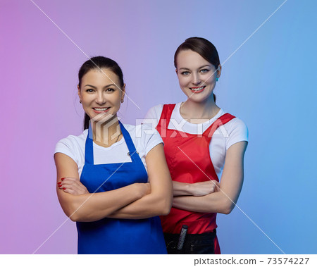 two girls-hairdressers in the studio. Asian and Caucasian appearance. 73574227