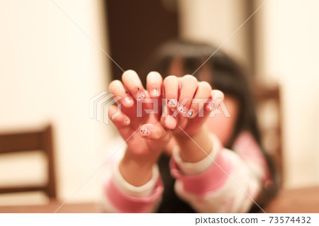 Girl's hand showing nails Girl's hand showing nails 73574432
