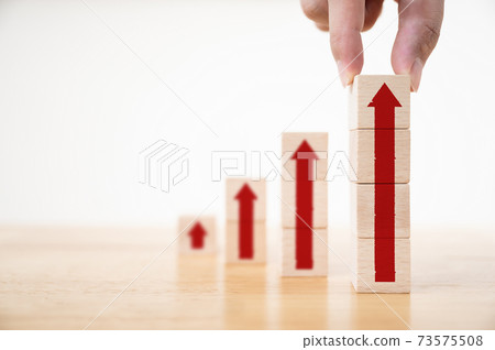 Hand arranging wood block stacking as step stair with arrow up Hand arranging wood block stacking as step stair with arrow up 73575508