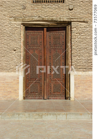 Old carved wooden door from turk castle medieval era. Medieval Mausoleum of Khawaja Ahmed Yasawi in the city of Turkestan, in southern Kazakhstan. Silk Road Legacy Tour. Old carved wooden door from turk castle medieval era. Medieval Mausoleum of Khawaja Ahmed Yasawi in the city of Turkestan, in southern Kazakhstan. Silk Road Legacy Tour. 73577069