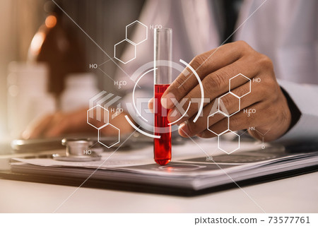 Lab work, Doctor holds a test tube takes the test from a test tube in analysis, blood, DNA, test tube stand. Lab work, Doctor holds a test tube takes the test from a test tube in analysis, blood, DNA, test tube stand. 73577761