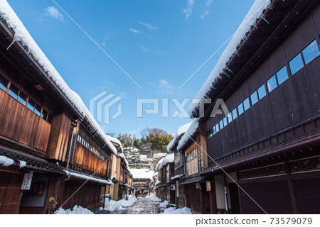 Higashi Chaya district with a snowy landscape with a blue sky 73579079