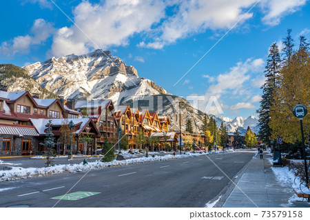 Banff High School Transit Hub bus stop. Banff Avenue in a snowy sunny day. Canadian Rockies. Banff High School Transit Hub bus stop. Banff Avenue in a snowy sunny day. Canadian Rockies. 73579158