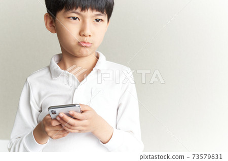 Boy with a dissatisfied face 73579831