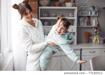 Mother with little daughter in a room 73580422