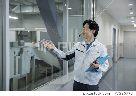 Male worker who guides factory tours Factory tour guide Male worker who guides factory tours Factory tour guide 73580776