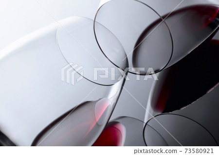 Glasses of red wine on a black reflective background. Glasses of red wine on a black reflective background. 73580921
