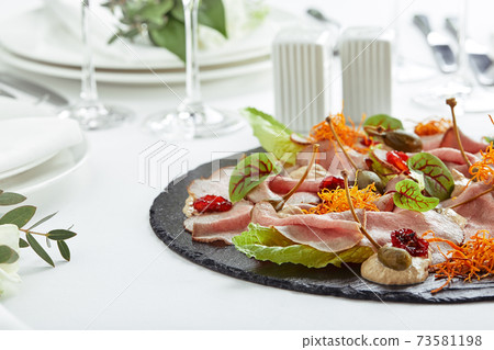 Beautifully decorated catering banquet table with different food snacks and appetizers Beautifully decorated catering banquet table with different food snacks and appetizers 73581198