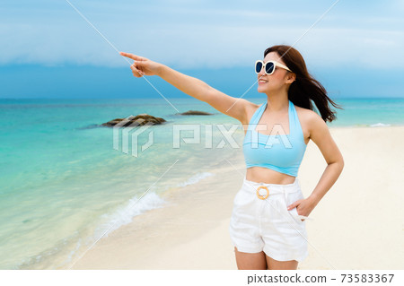 cheerful woman on sea beach at Koh MunNork Island, Rayong, Thailand cheerful woman on sea beach at Koh MunNork Island, Rayong, Thailand 73583367