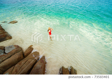 happy woman walking on sea beach at Koh MunNork Island, Rayong, Thailand happy woman walking on sea beach at Koh MunNork Island, Rayong, Thailand 73583401