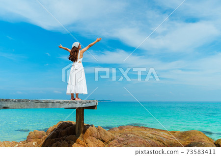 woman with arm raised on wood bridge and sea beach at Koh MunNork Island, Rayong, Thailand woman with arm raised on wood bridge and sea beach at Koh MunNork Island, Rayong, Thailand 73583411