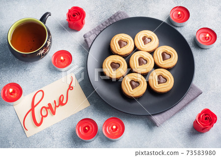 Homemade cookies in the shape of hearts on the plate, gray background. Concept Valentine's Day. copy space. Homemade cookies in the shape of hearts on the plate, gray background. Concept Valentine's Day. copy space. 73583980